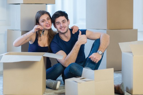 Professional movers carefully packing household items